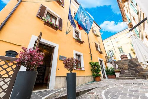a building with a flag on the side of it at Antico Borgo Chieti in Chieti