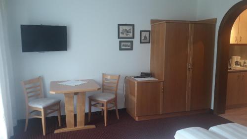 a room with a table and chairs and a cabinet at Haus Schnetzer in Schruns-Tschagguns