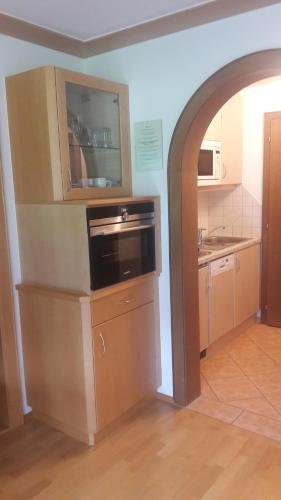 a kitchen with a stove and a microwave at Haus Schnetzer in Schruns-Tschagguns