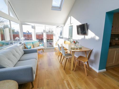 a living room with a couch and a table at Clyd Fan in Harlech