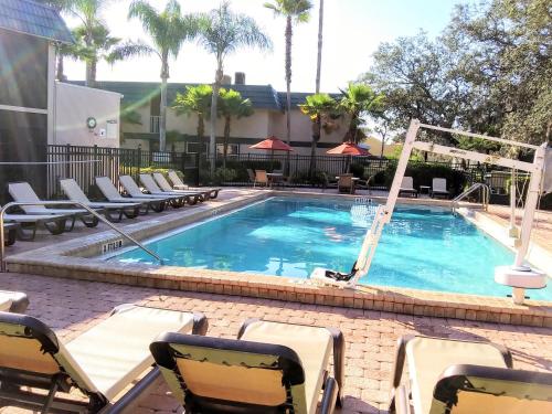 a swimming pool with lounge chairs at Grand Lake & Lifetime of Vacations Resorts in Orlando