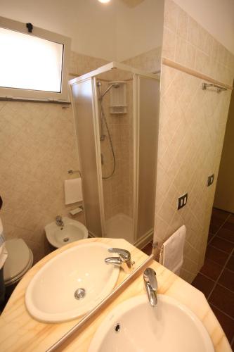a bathroom with a sink and a shower and a toilet at Porta del Vento in Giardini Naxos
