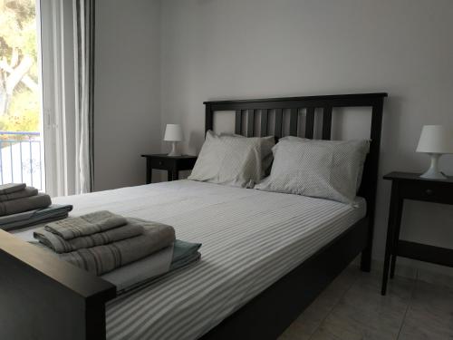 a bedroom with a large bed with white sheets and pillows at Athani Summer House (Apartments 01 - 02) in Athanion