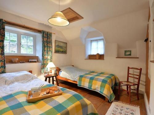 a bedroom with two beds and a tray with fruit on it at Pantlleni in Beddgelert