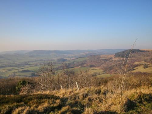 a view of a hillside with trees and fields at The Byre in Thirsk