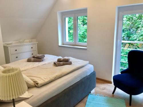 a bedroom with a bed and a chair and a window at Green Buda Valley: Holiday home with garden in Budapest