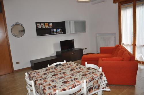 a living room with a table and a couch at GiaLoSa Biker House in Villa Verucchio