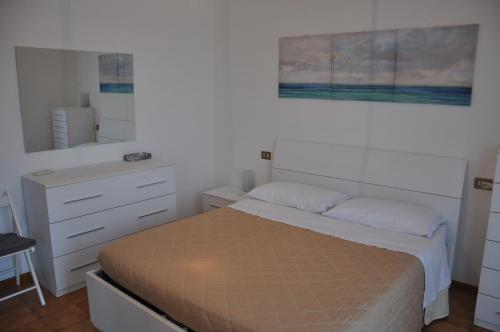 a small bedroom with a bed and a dresser at GiaLoSa Biker House in Villa Verucchio