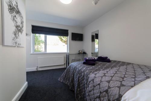 a bedroom with a bed and a window at The Norna in Cambridge