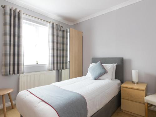 Ένα ή περισσότερα κρεβάτια σε δωμάτιο στο Clydesdale Hotel