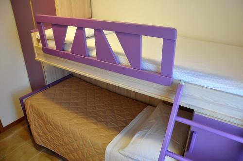 a purple bunk bed in a room at GiaLoSa Biker House in Villa Verucchio
