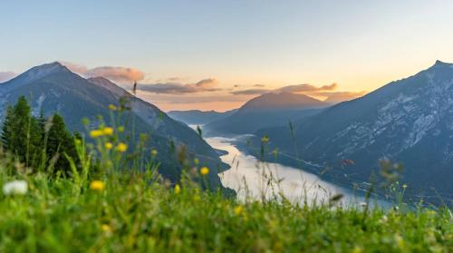 a view of a river in a valley in the mountains at Haus Bauer in Pertisau