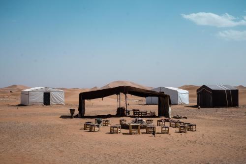 a group of tents and chairs in the desert at Kasbah Aitisfoul in Tagounite