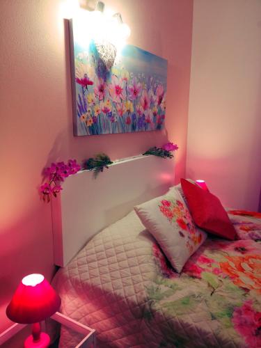 a bedroom with a bed and a painting on the wall at Nature Guesthouse in Lagos