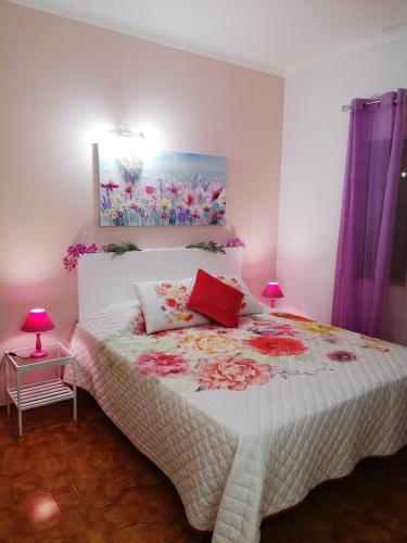 a bedroom with a bed and a painting on the wall at Nature Guesthouse in Lagos
