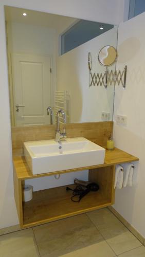 a bathroom with a white sink and a mirror at Weingut Endesfelder in Mehring