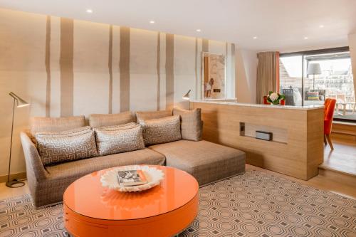 a living room with a couch and a table at The Marylebone Hotel in London