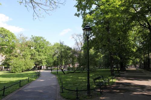 a park with a lamp post and benches at Bentis Luxury Apartments in Kraków
