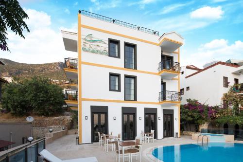 a villa with a swimming pool and a resort at Enda Boutique Hotel Kalkan in Kalkan