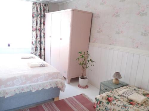 a bedroom with a bed and a dresser at Lille Lux Apartment in Viljandi