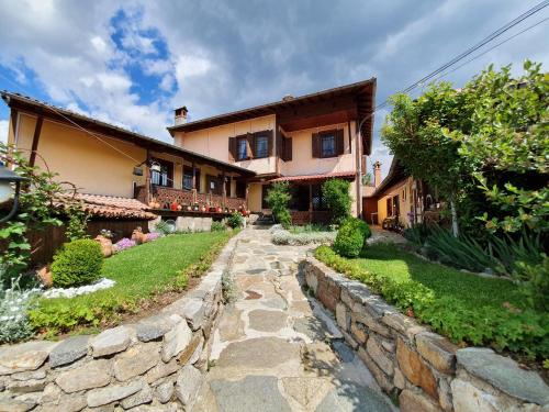 a stone path in front of a house at Guest rooms Colorit in Koprivshtitsa