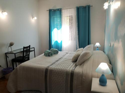 a bedroom with a bed and a table with a lamp at Nature Guesthouse in Lagos