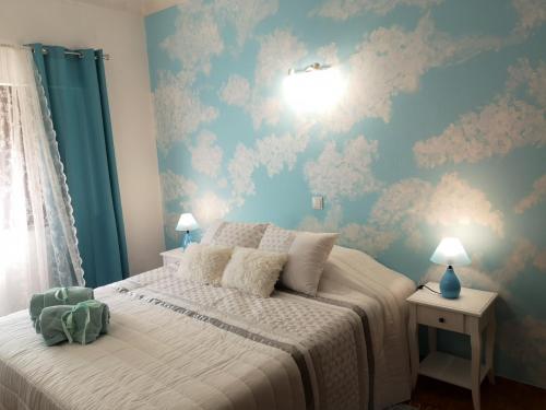 a bedroom with a bed with a blue wall at Nature Guesthouse in Lagos