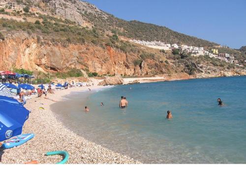 a group of people in the water at a beach at Enda Boutique Hotel Kalkan in Kalkan