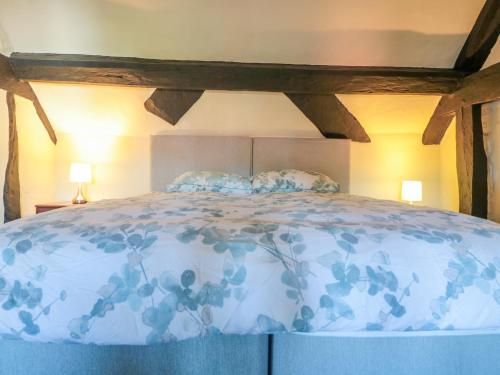 a bed with two pillows on top of it at River Cottage in Tewkesbury