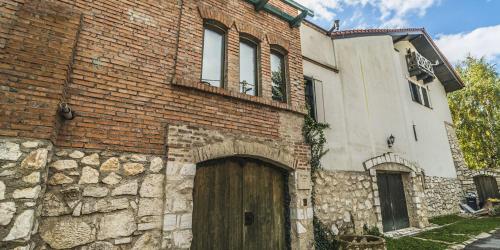 a brick building with a wooden door in front of it at Vila Terrasse in Košice