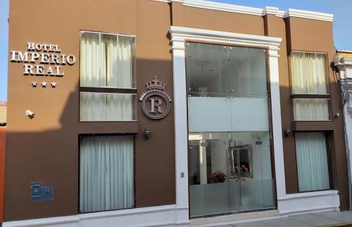 a building with a hotel impero real sign on it at Hotel Imperio Real in Trujillo