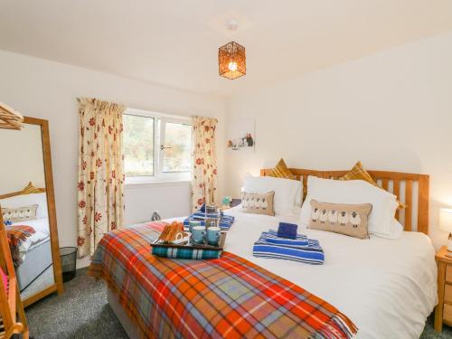 a bedroom with a bed and a mirror at Pier View in Dunoon