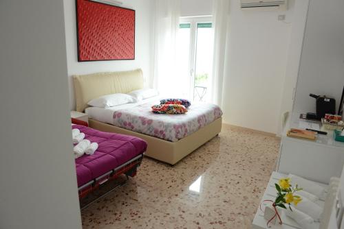 a bedroom with two beds and a window at Dimore Pietrapenta Apartments, Suites & Rooms - Via Lucana 223, Via Piave 23, Via Chiancalata 16, Vico Fornaci 9 in Matera