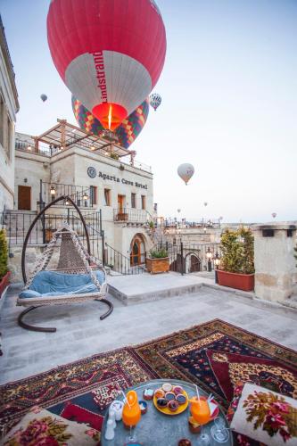 a hot air balloon is flying over a building at Agarta Cave Hotel in Goreme