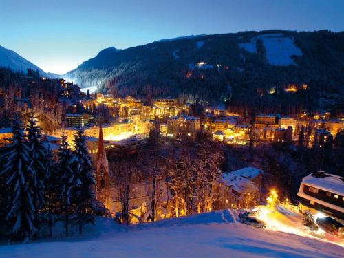 a view of a town in the snow at night at Hotel Salzburger Hof in Bad Gastein