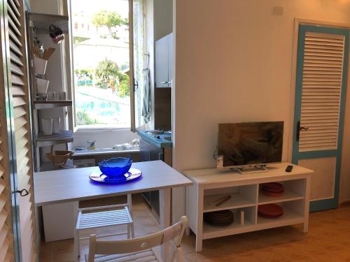a kitchen with a table with a bowl on it at Casa Nanà in Santo Stefano al Mare