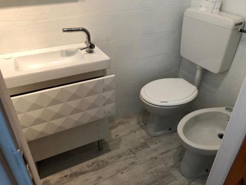 a bathroom with a toilet and a sink at Casa Nanà in Santo Stefano al Mare