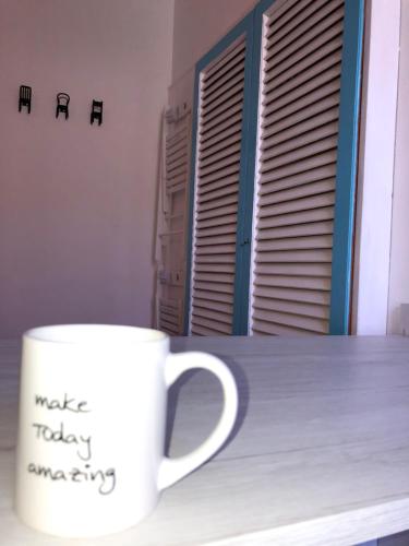 a coffee cup sitting on a table next to a window at Casa Nanà in Santo Stefano al Mare