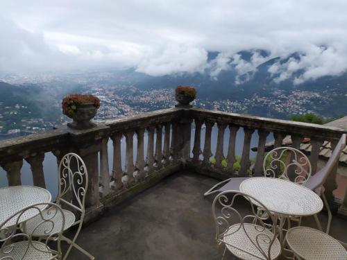 a balcony with chairs and a view of a city at B&B Il Balcone sul Lago in Brunate