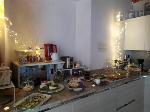 a kitchen with some food on a counter with lights at B&B Il Balcone sul Lago in Brunate