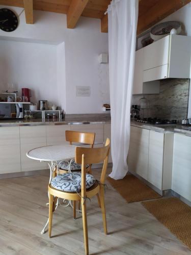 a kitchen with a table and two chairs and a table at B&B Il Balcone sul Lago in Brunate