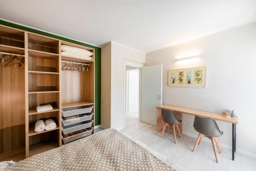 a bedroom with a desk and a closet at Casa Bella in Argegno