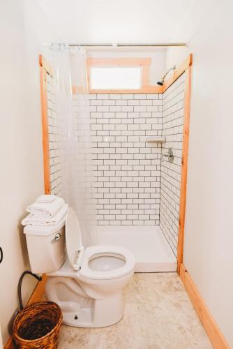 a bathroom with a toilet and a shower at Rainbow Mountain Resort - LGBTQ Friendly in East Stroudsburg