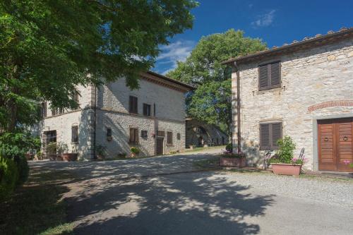 an alley in front of a stone building at Relais Santa Cristina in Radda in Chianti