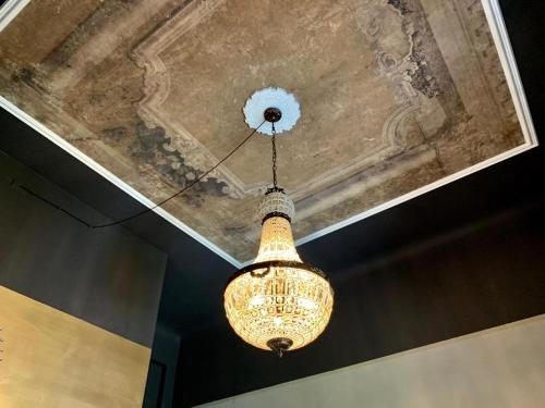 a chandelier hanging from a ceiling in a room at Villa Tower Inn in Pisa