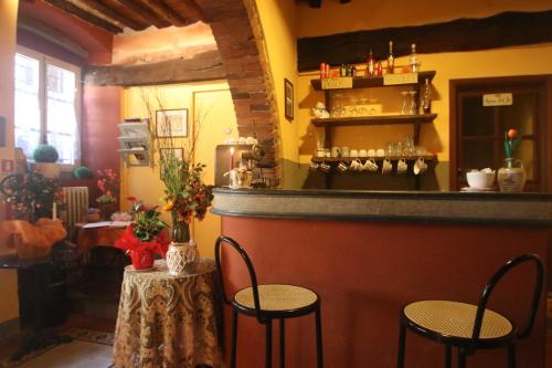 a bar with two chairs and a counter in a room at Antica Casa Dei Rassicurati in Montecarlo