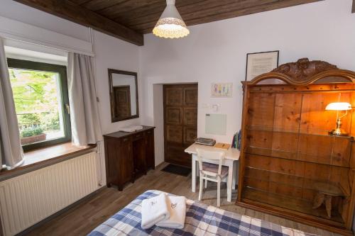 1 dormitorio con cama, mesa y ventana en Slabnik Nature Escape, en Idrija