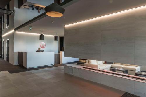 a lobby with couches and a counter in a building at Hôtel & Suites Normandin Lévis in Lévis