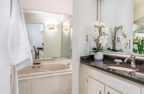 a bathroom with a sink and a mirror at Harbor Light Inn in Marblehead