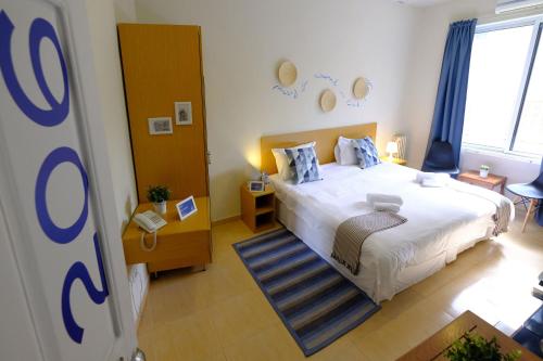 a bedroom with a large bed and a large window at Hotel Wakim in Broummana